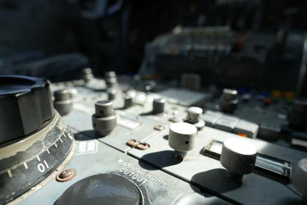 Nahaufnahme eines Bedienfelds mit Schaltern und Drehknöpfen im Cockpit einer Boeing 747